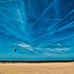 Scenic view of beach against blue sky