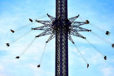 Low angle view of chain swing ride against sky