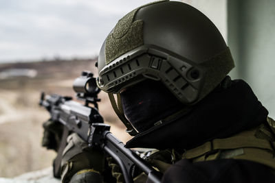 Close-up of army soldier aiming gun