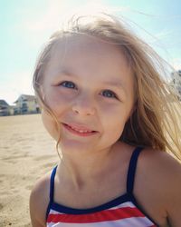 Close-up portrait of girl smiling at beach