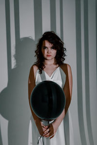 Portrait of young woman holding wineglass