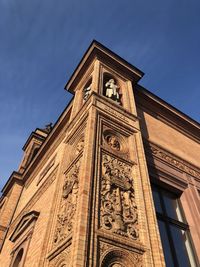 Low angle view of clock tower against sky