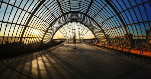 View of empty bridge against sky during sunset