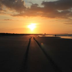 Scenic view of beach against sky during sunset