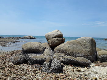 Rocks on beach against sky