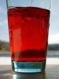 Close-up of red wine in glass on table