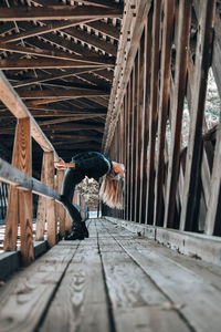 Woman exercising on footbridge