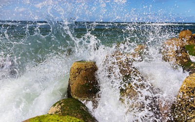 Water splashing in sea against sky