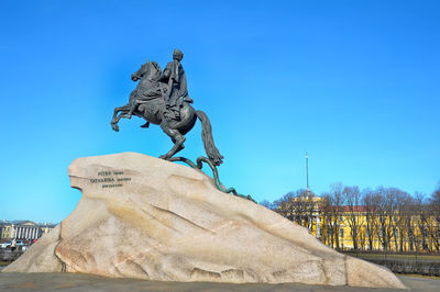 Low angle view of statue against blue sky