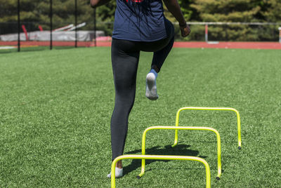 Low section of man standing on soccer field