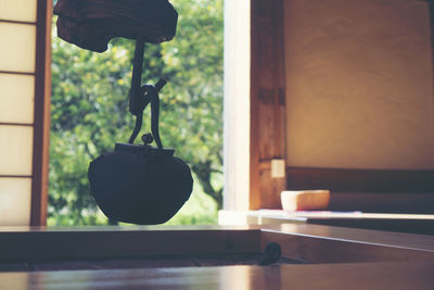 Close-up of glass window hanging on table at home