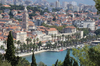 High angle view of buildings in town by lake