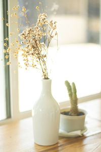 Close-up of flower vase on table