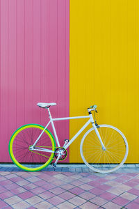 Bicycle parked against wall