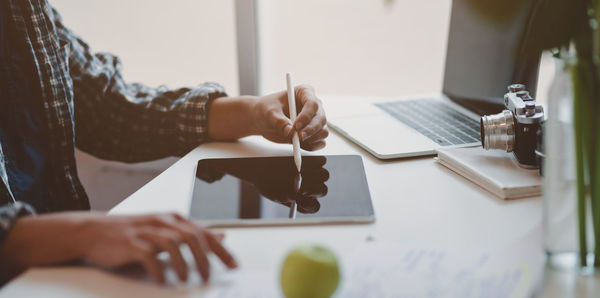 Midsection of woman working on table