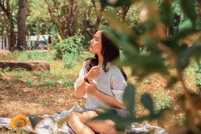 Young woman sitting outdoors