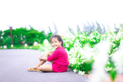 Portrait of cute girl sitting outdoors