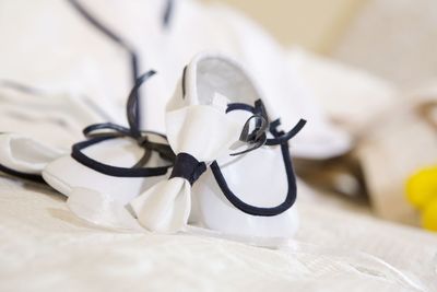 Close-up of white baby booties on table