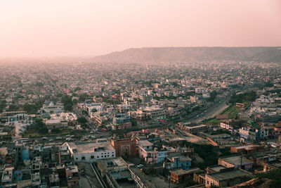 Aerial view of townscape against sky during sunset