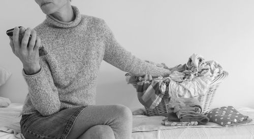 Midsection of man sitting at home