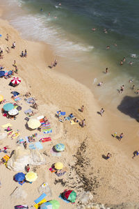 High angle view of people enjoying at beach