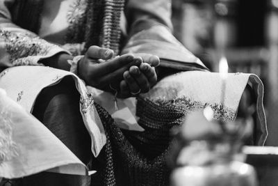 Midsection of bridegroom wearing wedding dress during ceremony