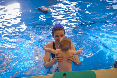 Low section of woman swimming in pool