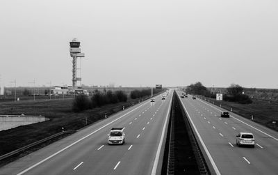 Cars on highway against clear sky