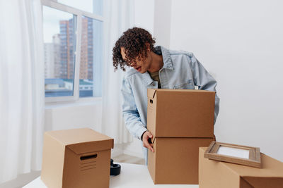 Side view of man with cardboard box