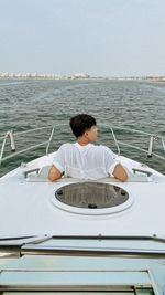 Rear view of woman in boat
