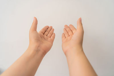 Close-up of hands against white background