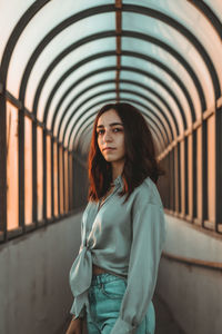 Portrait of beautiful young woman standing on a train station 