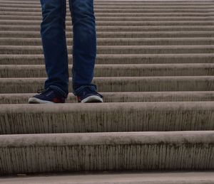 Low section of man standing on steps