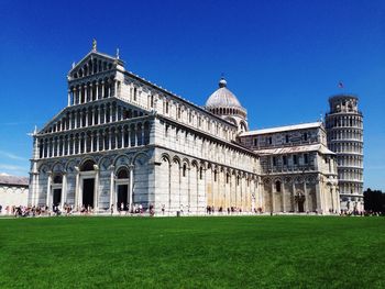 Facade of lawn against clear blue sky