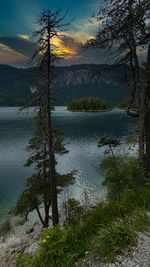 Scenic view of lake against sky at sunset