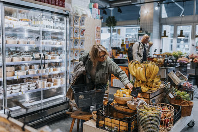 Senior woman buying bananas in supermarket