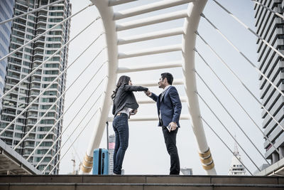 Business colleagues talking while standing in city