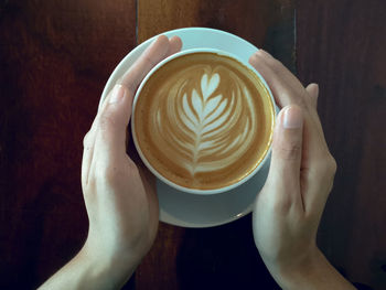 Midsection of woman holding coffee cup