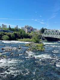 Bridge over river against blue sky