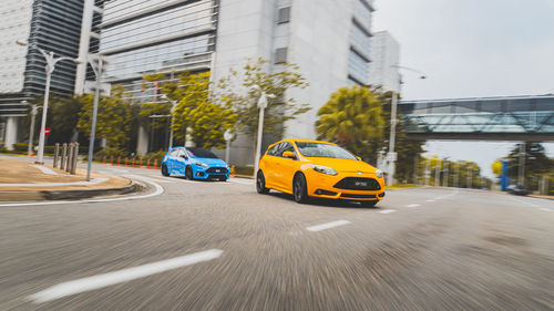 View of yellow car on road