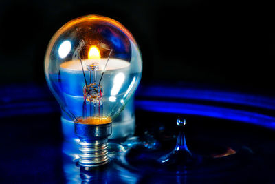 Close-up of illuminated light candles on table