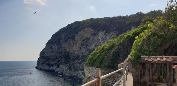 Scenic view of sea and mountains against sky