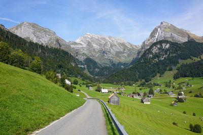 Road amidst mountains against sky