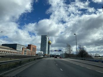 City street against cloudy sky