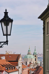 Street light in city against sky