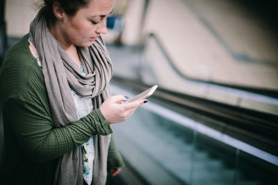 Midsection of man using mobile phone