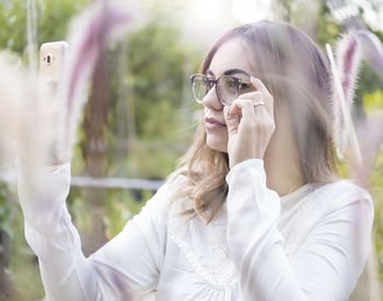 Portrait of young woman photographing