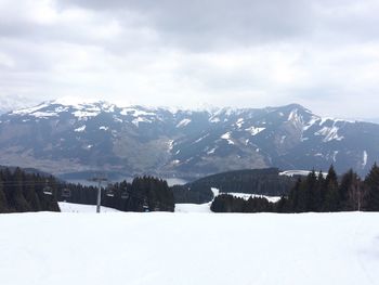 Scenic view of snow covered mountains against sky