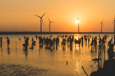 People on beach at sunset