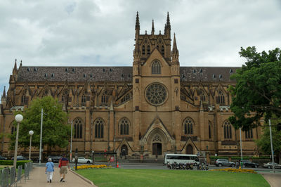 Low angle view of building against cloudy sky